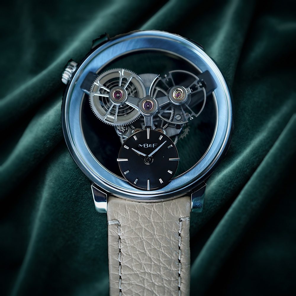 Platinum MB&F watch with a skeletonised movement on dark green velvet
